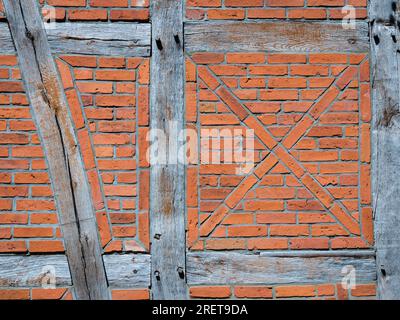 Old wall made of brown half-timbered, bricked with bricks in different shades Stock Photo