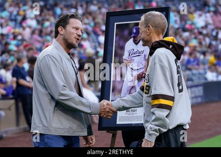 Former San Diego Padres pitcher Jake Peavy, left, reacts as he is inducted  into the Padres Hall of Fame, alongside owner Peter Seidler before a  baseball game against the Texas Rangers Friday