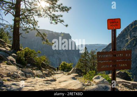 Morning sun bathes the John Muir Trail, leading adventurers towards Yosemite Valley. Stock Photo