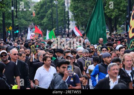 London, UK. 29th July, 2023. The Shia muslim community commemorated the sacrifice and martyrdom of Imam Hussain in the annual Ashura procession through the West End. This year, specially printed quran covers were distributed to participants denouncing several burnings of the holy book in Denmark and Sweden this year, and also calling for legal protections against such acts. Credit: Eleventh Hour Photography/Alamy Live News Stock Photo