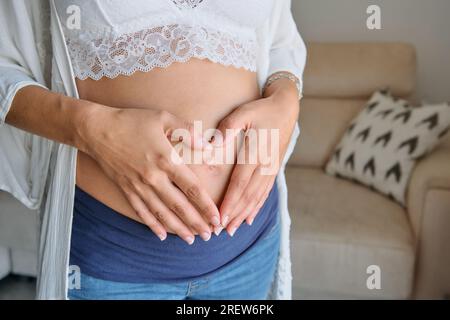 Pregnant woman in bra and jeans hi-res stock photography and images - Alamy