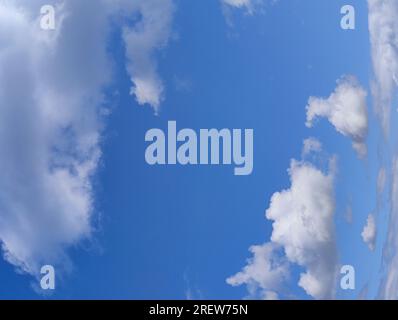 Unusual distorted white cloudscape over blue sky background Stock Photo