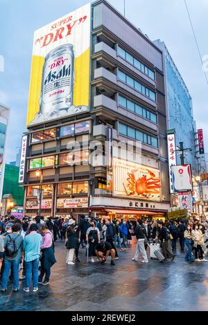 The popular Kani Doraku restaurant with its famous mechanical crab sign above the main entrance and the neon berry can sign at Dotonbori, Osaka. Night. Stock Photo