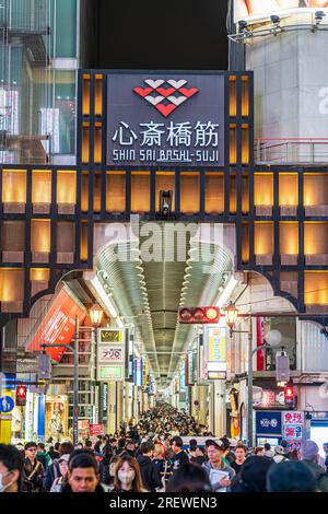 Night time view from the Ebisu bridge at Dotonbori, Osaka, of the entrance to the very long covered and crowded shopping street, Shin Sai bashi suji. Stock Photo