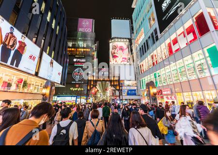 Night time view from the Ebisu bridge at Dotonbori, Osaka, of the entrance to the very long covered and crowded shopping street, Shin Sai bashi suji. Stock Photo