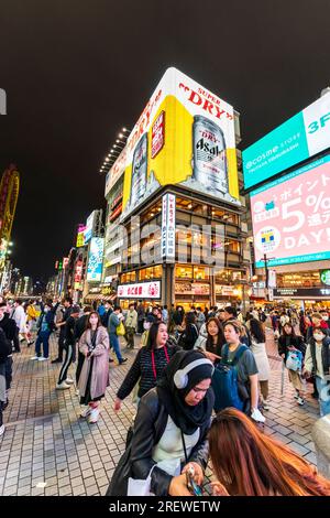 Night view of the Kani Doraku restaurant building with it's giant neon sign of a Asahi beer can. seen from the Ebisu Bridge at Dotonbori, Osaka. Stock Photo