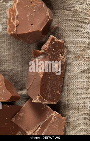 broken into several parts pieces of chocolate from cocoa, natural food from cocoa, sugar, cocoa butter, pieces of large natural real chocolate Stock Photo