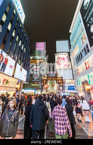 Night time view from the Ebisu bridge at Dotonbori, Osaka, of the entrance to the very long covered and crowded shopping street, Shin Sai bashi suji. Stock Photo