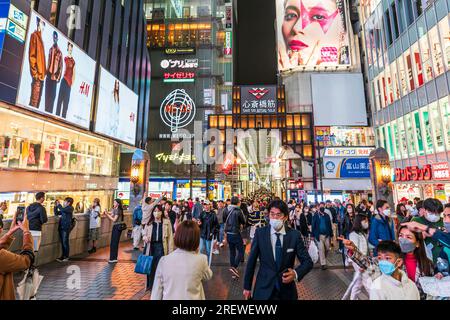 Night time view from the Ebisu bridge at Dotonbori, Osaka, of the entrance to the very long covered and crowded shopping street, Shin Sai bashi suji. Stock Photo