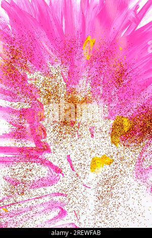 On a white background, pink streaks of watercolor are sprinkled with gold sparkles. Stock Photo