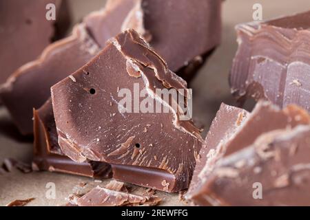 pieces of large natural real chocolate, broken into several parts pieces of chocolate from cocoa, natural food from cocoa, sugar, cocoa butter Stock Photo