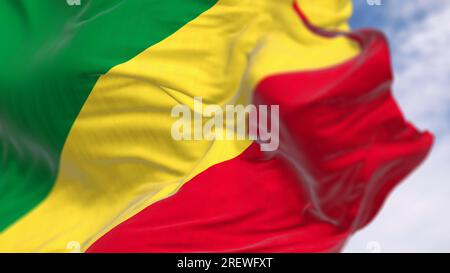 Republic of the Congo national flag waving in the wind on a clear day. Diagonal tricolor with green, yellow, and red stripes. 3d illustration render. Stock Photo