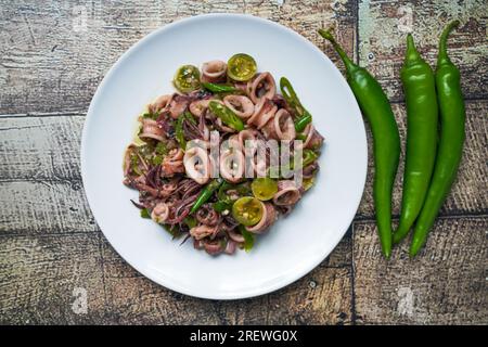 Cumi Cabe Ijo, Spicy Stir Fry Squid with Green Pepper, Green chili and green tomatoes Stock Photo