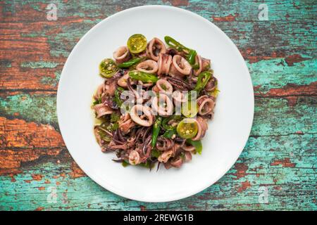 Cumi Cabe Ijo, Spicy Stir Fry Squid with Green Pepper, Green chili and green tomatoes Stock Photo