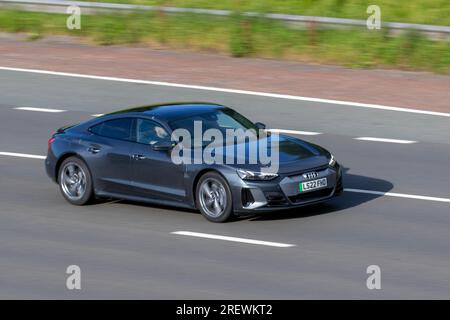 2022 Grey AUDI E-TRON GT Quattro, 530 Quattro Electric 93.4Kwh Grey Car Saloon Electricity 390 kW; travelling at speed on the M6 motorway in Greater Manchester, UK Stock Photo