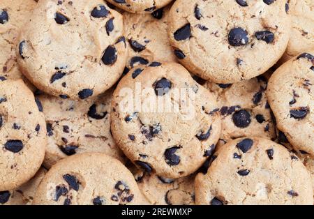 drops and pieces of chocolate in traditional wheat cookies, food for tea or coffee, sweet and delicious cookies Stock Photo