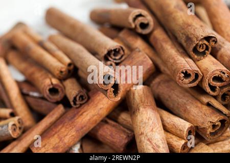 aromatic solid cinnamon used to make aromatic and delicious spices for baking rolls and cooking other dishes, close up of whole cinnamon sticks Stock Photo