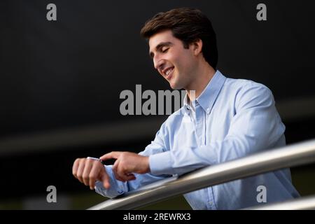 Young man using smart watch. Businessman uses smartwatch Stock Photo