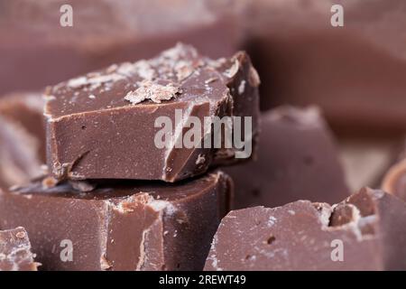 pieces of large natural real chocolate, broken into several parts pieces of chocolate from cocoa, natural food from cocoa, sugar, cocoa butter Stock Photo