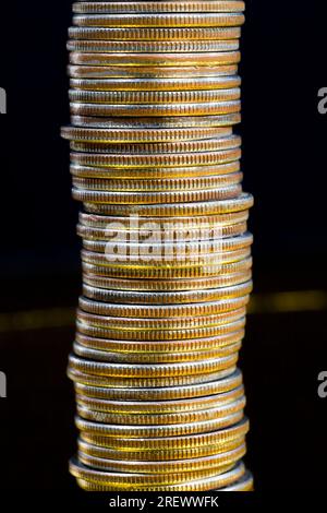 copper small coins close up, the coin is stacked together in piles used for payments in the state, a quarter of the us dollar is a 25 cent coin as leg Stock Photo