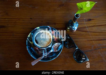 Americano without sugar Hot Beverage in a Glass Cup served with saucer and spoon Stock Photo