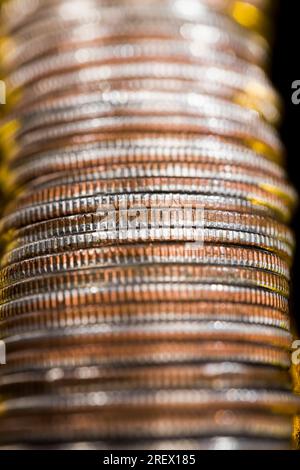 copper small coins closeup, the coin is stacked together in piles used for payments in the state, a quarter of the us dollar is a 25 cent coin as lega Stock Photo