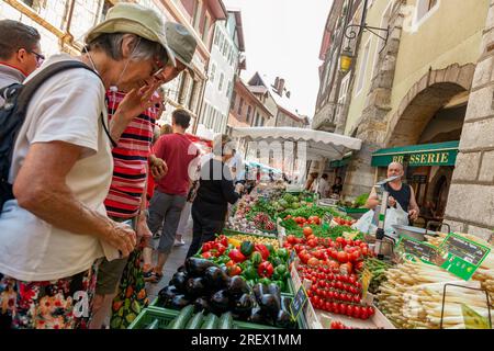 2014-06-22 Annecy, France. People shopping seasonal fruits and vegetables on the local city marketplace. Dynamic photo with tilt. Selective focus on f Stock Photo