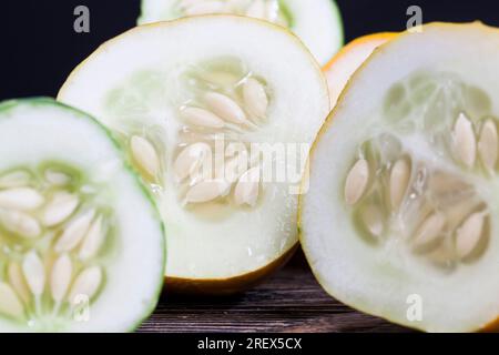cut into half a ripe old cucumber, the seeds from which can be used to produce a new crop of cucumbers Stock Photo