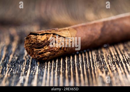 tobacco from a crumbling cigarette on the board, dangerous tobacco from  cigarettes, tobacco from cigarettes causing nicotine addiction Stock Photo 