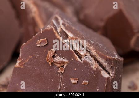 broken into several parts pieces of chocolate from cocoa, natural food from cocoa, sugar, cocoa butter, pieces of large natural real chocolate Stock Photo