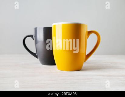 Two blank tea cups or coffee mugs. Responsive design mockup. Selective focus. Stock Photo
