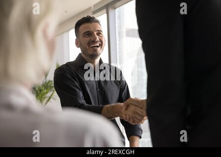 Happy candidate man getting job, shaking hands Stock Photo