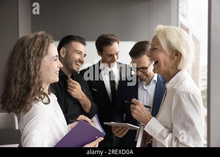 Cheerful business colleagues women talking, enjoying funny conversation Stock Photo