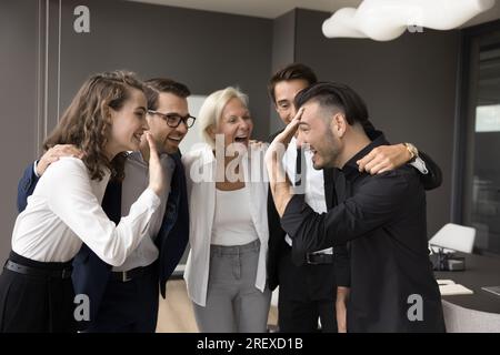Cheerful team of professionals giving group high five Stock Photo