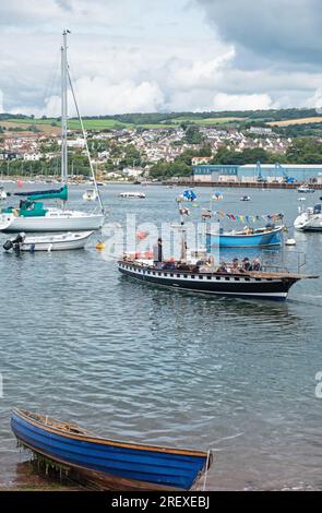 Teignmouth, England – July 21, 2023: The year round passenger ferry that crosses between the town and Shaldon on the opposite banks of the river Teign Stock Photo