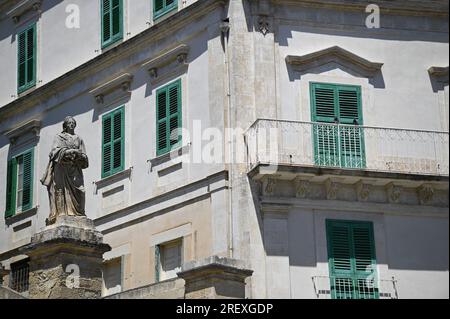 Antique sculpture front of a Neoclassical style building on Piazza San Giovanni in Modica, Ragusa Sicily, Italy. Stock Photo