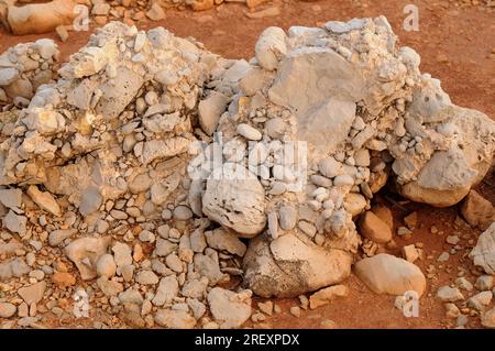 Conglomerate is a clastic sedimentary rock composed of rounded clasts (pudding stone). This photo was taken in Menorca, Balearic Islands, Spain. Stock Photo