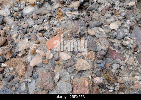 Conglomerate is a clastic sedimentary rock composed of rounded clasts (pudding stone). This photo was taken in Pals, Girona, Catalonia, Spain. Stock Photo