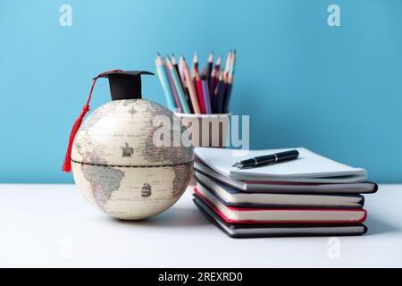Graduation cap with Earth globe. Concept of global business study, abroad educational, Back to School, Study abroad business in universities. Elements Stock Photo