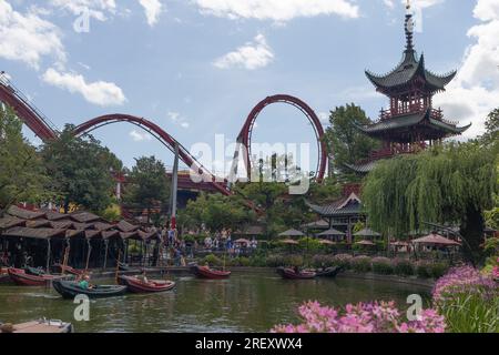 Copenhagen, Denmark. July 25th, 2023. A general view of the  Tivoli Gardens Pagoda, Dragon Boats and The Demon rollercoaster ride. Credit: Katie Collins/Alamy Stock Photo