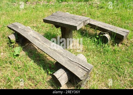 Log benches and table in nature for picnic Stock Photo