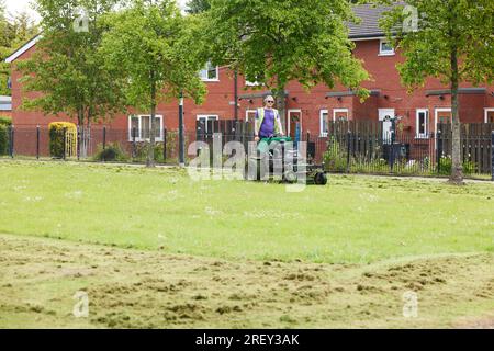 Council ride on lawn mower in Preston, Lancashire Stock Photo