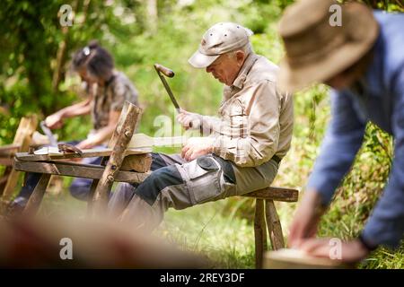 Traditional woodwork skills, wood chopping in the woodland Stock Photo