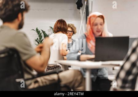 Group of diverse people communicating and working on a project in groups Stock Photo