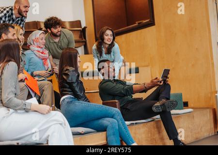 Young and enthusiastic group of businesspeople taking a selfie all together at the office Stock Photo