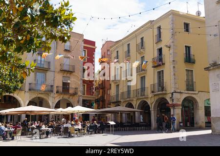 Figueres, Spain, May 14, 2023: A street cafe in the city center, people are sitting at tables served by a waiter. Stock Photo