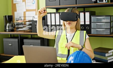 Young blonde woman architect using virtual reality glasses drawing at office Stock Photo