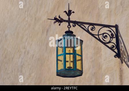 Vintage forged street lamp on wall Stock Photo