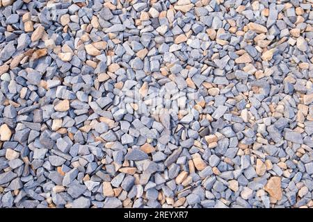 Gray small rocks ground texture. pebbles stone  texture. background of crushed granite gravel, close up. clumping clay Stock Photo