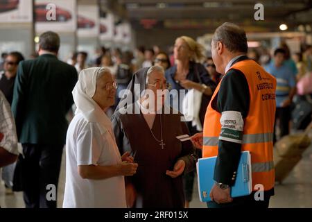 Trenitalia platform staff helping passengers at Milan's busy mainline railway station, the Italian national railway system, 2005 Stock Photo